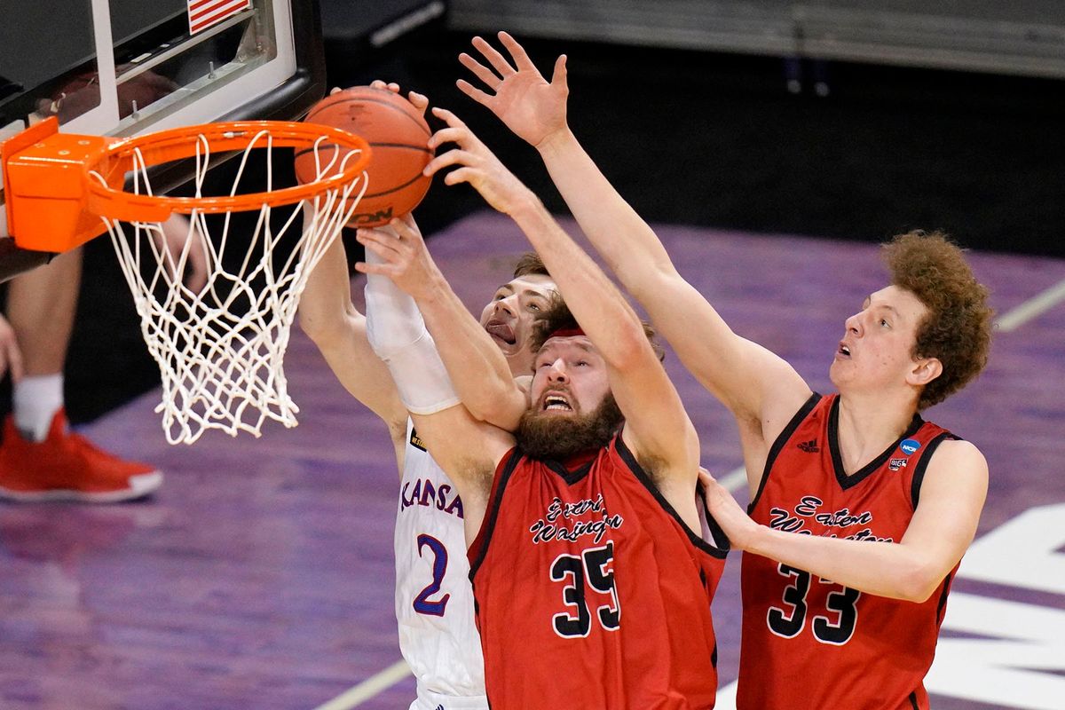 Kansas guard Christian Braun, left, Eastern Washington forward Tanner Groves, center, and EWU’s Jacob Groves battle for a rebound during the second half of Saturday’s NCAA Tournament first-round game at Farmers Coliseum in Indianapolis.  (AJ Mast/Associated Press)