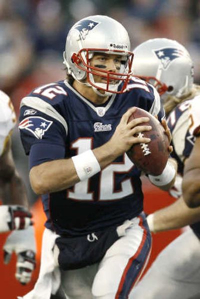 
Tom Brady threw for three scores and ran for two more. Associated Press
 (Associated Press / The Spokesman-Review)