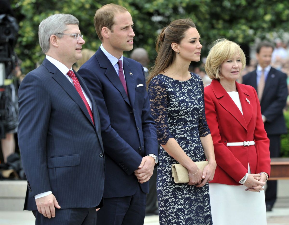 Prince William and Kate, the Duke and Duchess of Cambridge and Canada Prime Minister Stephen Harper and his wife Laureen pause at the War Memorial in Ottawa, Canada, on their first official overseas trip Thursday, June 30, 2011. (Paul Chiasson / The Canadian Press)