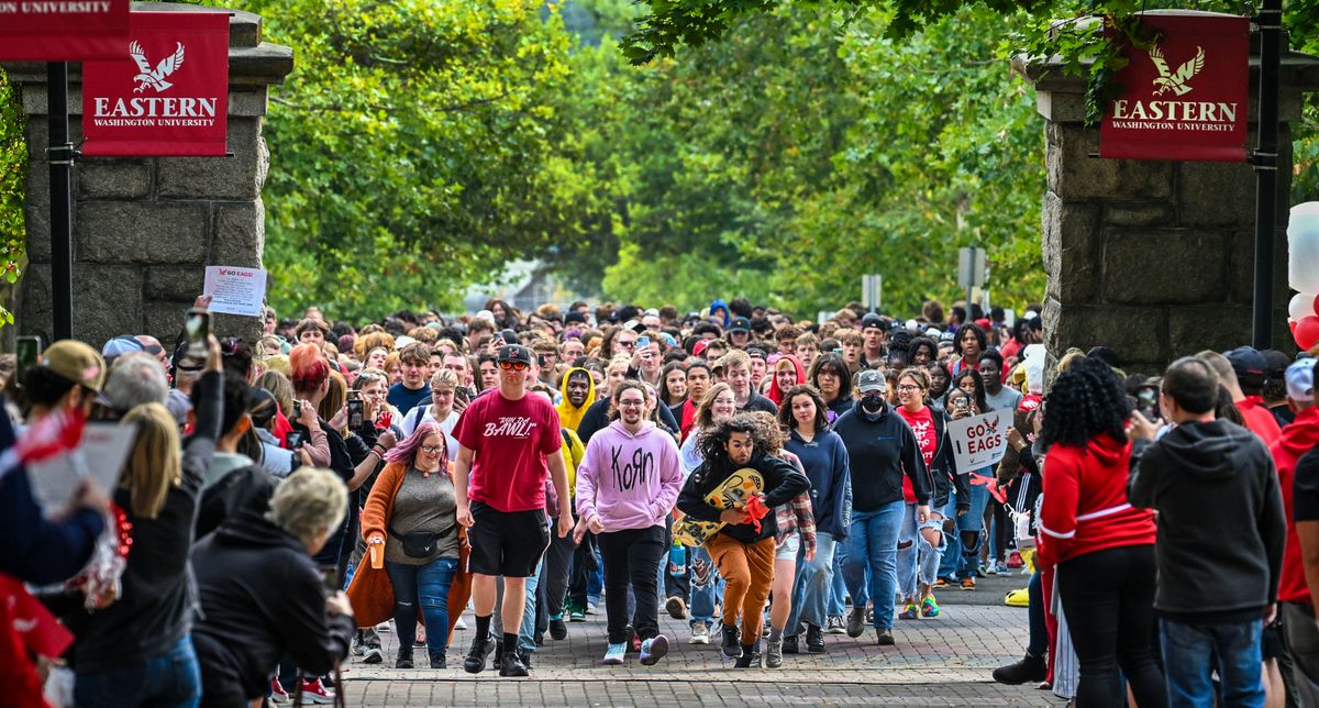 New Eastern Washington University students participate in the Pass Through the Pillars ceremony, Tuesday, Sept. 19, 2023, in Cheney, Wa. Hundreds of freshman students recreated the path generations of students once took from CheneyÕs downtown train depot to their new collegiate homes.  (DAN PELLE/THE SPOKESMAN-REVIEW)