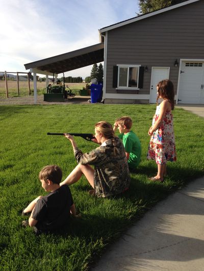Long-range lessons: Olympic shooter Amanda Furrer, 23, flew into Spokane recently to be with family and celebrate being named to the 2014 U.S. Women’s World Championship Shooting Team. Furrer’s dad, Michael, who still coaches the Spokane Junior Rifle Team in which Amanda got her start, snapped this photo of Amanda giving her niece and nephews a few pointers with the ol’ Daisy BB gun in the family’s backyard. “This is where it starts,” he said, noting that the kids were casual and having fun but also in control with safety in mind. Michael already had taken the kids over to the garage in the background to show them the two dimples in the door where Amanda missed the target by 2 feet with her first pellet gun shots when she was their age. (Michael Furrer)