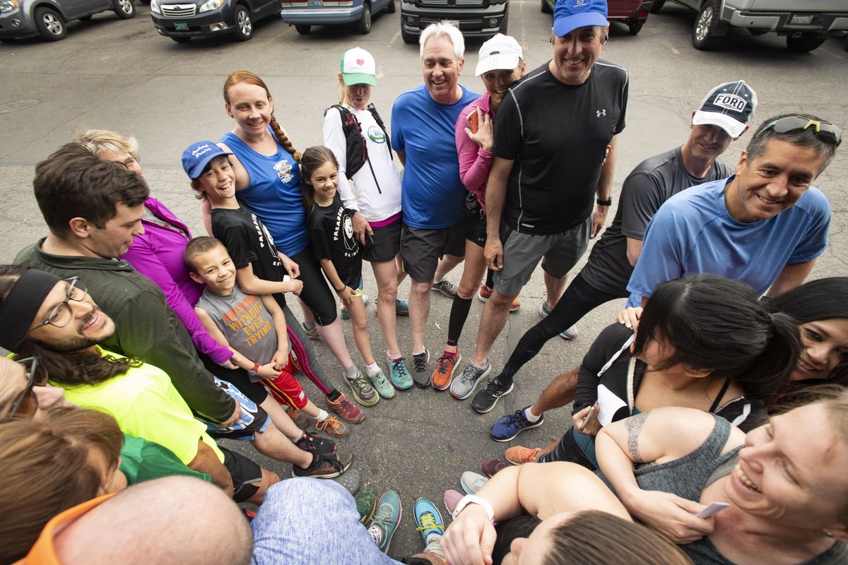 Each time before their Bloomsday training run, members of the Spokane Valley Running Club (the Bisons) create a circle with their running shoes outside the at the Monkey Bar on Monday, April 22, 2019, in the Spokane Valley. (Colin Mulvany / The Spokesman-Review)