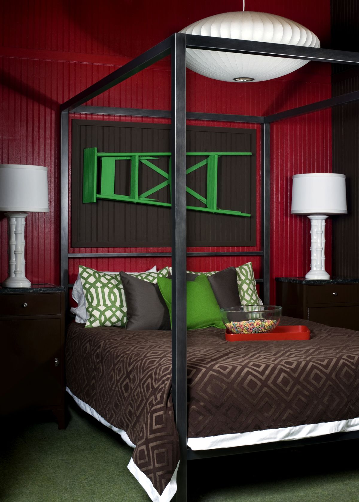 Brian Patrick Flynn designed this bedroom using a palette of black-brown, ultra-white, kelly green and fire engine red.