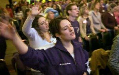 
Lisa Eidson of Des Moines, Wash., closes her eyes and sings at Campus Crusade for Christ's Greater Northwest Winter Conference at the Spokane Convention Center on Thursday morning. 
 (Photos by Holly Pickett/ / The Spokesman-Review)