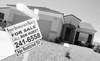 
A realty for sale sign hangs in front of a home on Cumberland Hill Drive in Henderson, Nev., outside Las Vegas.
 (Associated Press / The Spokesman-Review)