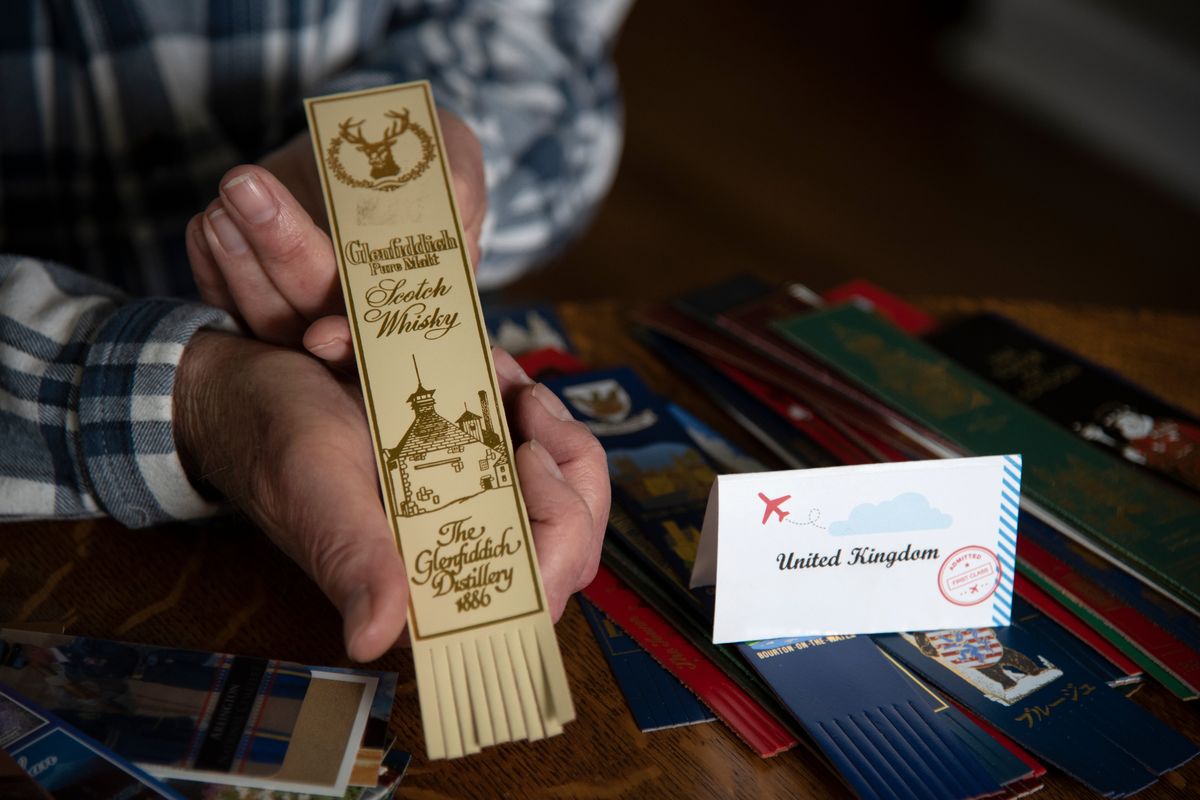 Bernie Korth, , who has traveled the world as a salesman for Keytronic, has documented his travels by purchasing bookmarks, many mad of leather, fabric and other materials, shown Wednesday, May 25, 2022. The one from the GlenFiddich Distillery is one of his favorites. The largest percentage of the collection are from the United Kingdom, where he lived for several years, but there are many from the Middle East, Asia and the North America. ,  (Jesse Tinsley/The Spokesman-Review)