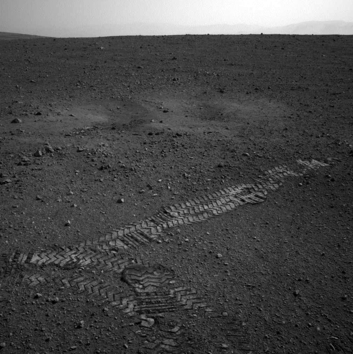 This image taken Wednesday and provided by NASA shows the Curiosity rover’s wheel tracks on the surface of Mars. (Associated Press)