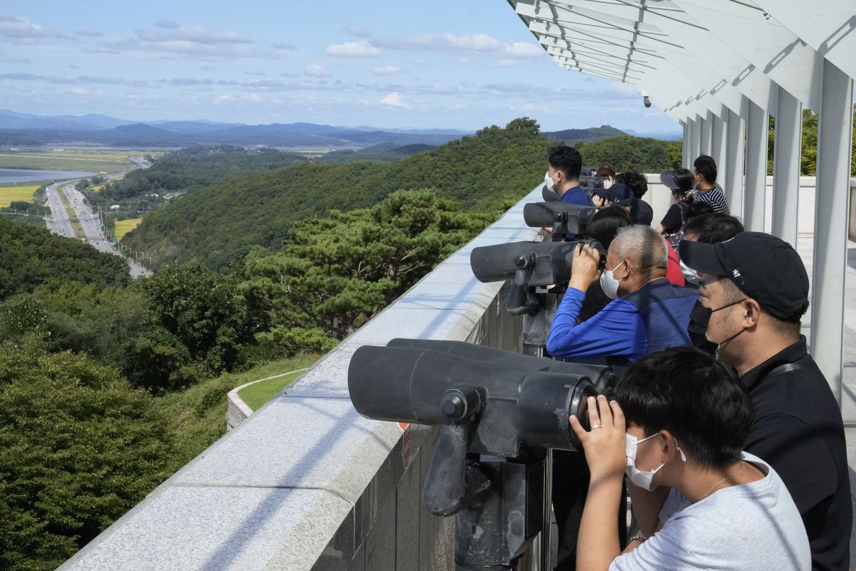 Visitors watch the North Korea side from the Unification Observation Post in Paju, South Korea, near the border with North Korea, Sunday, Sept. 26, 2021. The powerful sister of North Korean leader Kim Jong Un said Saturday that her country will take steps to repair ties with South Korea, and may even discuss another summit between their leaders, if the South drops what she described as hostility and double standards.  (Ahn Young-joon)