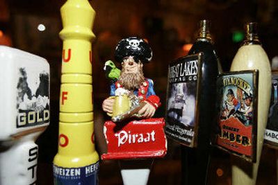 
An artsy tap handle of Piraat Belgian strong beer, third from left, is displayed at Surly Girl Saloon in Columbus, Ohio. Breweries have tried for decades to attract attention by making tap handles larger and more colorful, but the microbrewery movement has brought a proliferation of artsy and exotic ones. 
 (Associated Press / The Spokesman-Review)