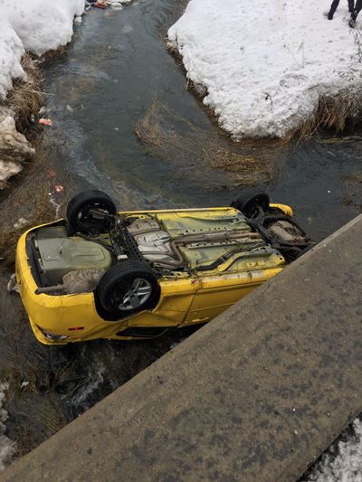 This car landed upside down in a creek near Highway 395 and Crawford Road on Tuesday, Jan. 24, 2017. (Spokane County Fire District 4)