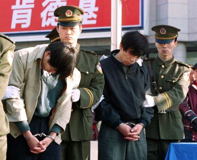 Criminals are paraded in handcuffs outside a shopping center in central Beijing. Several thousand people were executed in 2016 by China alone, while at least 1,032 were executed in 23 other countries globally, said Amnesty. (Associated Press)