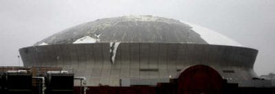 
The roof of the Louisiana Superdome is shredded by strong winds from Hurricane Katrina as it battered New Orleans on Monday.
 (Associated Press / The Spokesman-Review)