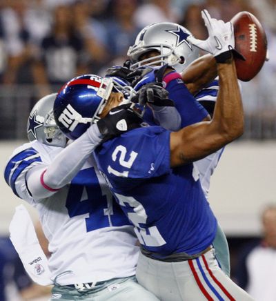 Giants’ Steve Smith makes a reception under intense pressure from Cowboys. (Associated Press)