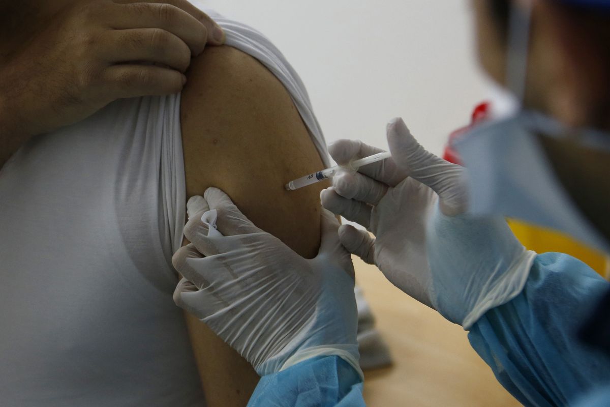 FILE - in this file photo dated Saturday, Jan. 30, 2021, a Moroccan nurse administers the Oxford AstraZeneca COVID-19 vaccine to a health worker, at Cheikh Khalifa Hospital in Casablanca, Morocco. The World Health Organization Monday Feb. 15, 2021, granted an emergency authorization to the coronavirus vaccine made by AstraZeneca, a move that should allow its partners to ship millions of doses to countries worldwide as part of a U.N.-backed program to stop the pandemic.  (Abdeljalil Bounhar)