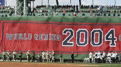 
A World Series banner is hung on the Green Monster at Fenway Park on Monday. 
 (Associated Press / The Spokesman-Review)