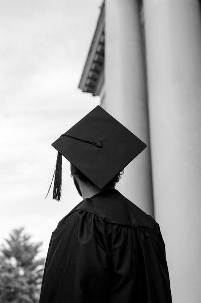 A student dons a cap and gown at Harvard University in Cambridge, Mass., on Oct. 4, 2022.  (DUMEBI MALAIKA MENAKAYA/New York Times)