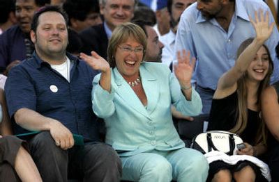 
Socialist presidential candidate Michelle Bachelet, center, waves during her closing campaign rally in Santiago, Chile, on Thursday. At left is her son Sebastian and at right her daughter Sofia. 
 (Associated Press / The Spokesman-Review)