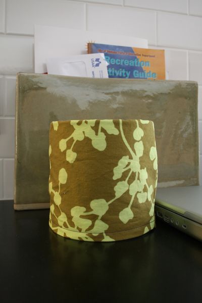 Just say no ... to plastic. Instead of buying new containers to hold pens, pencils, scissor and other small items, sew slipcovers for old coffee cans. (Megan Cooley)