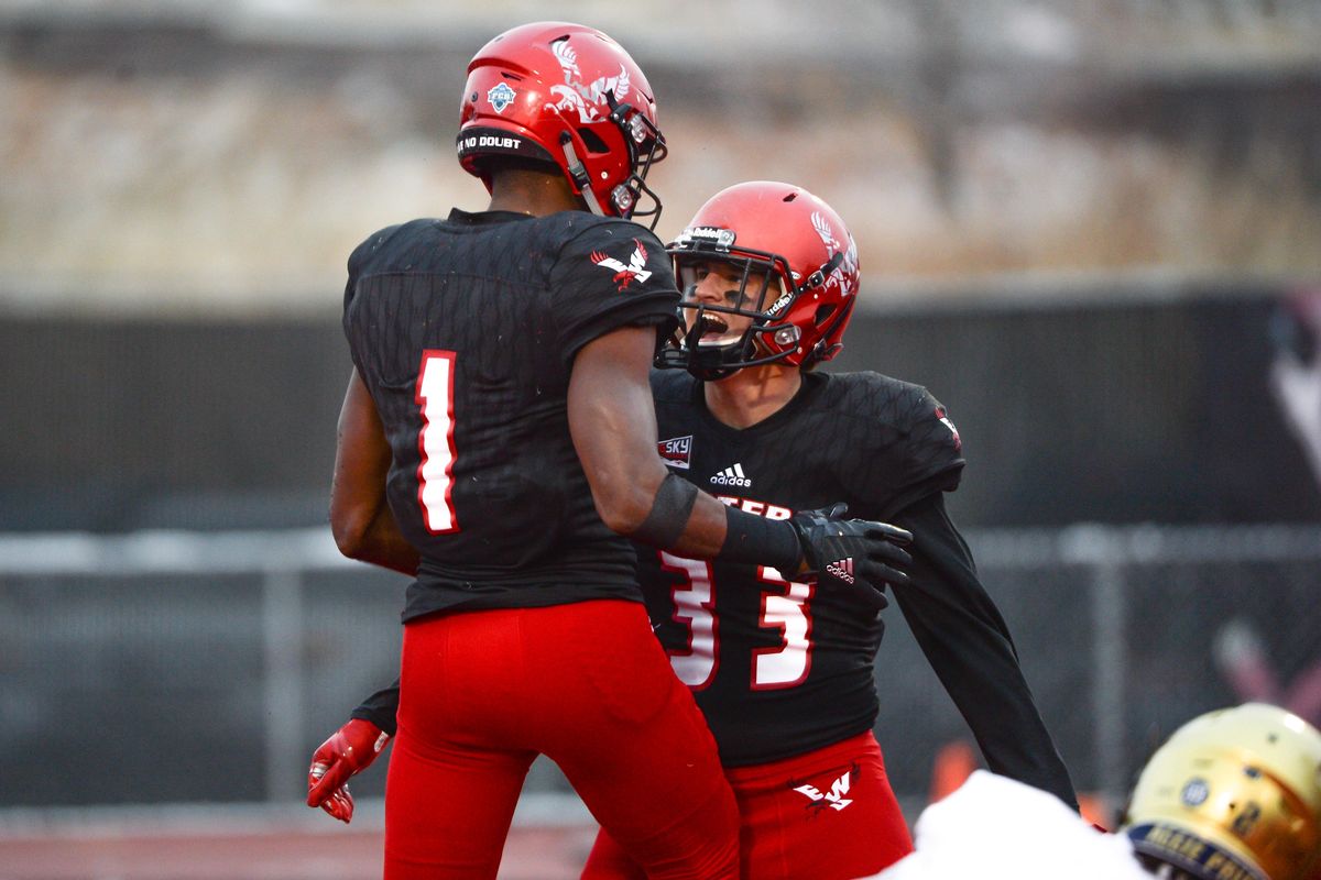 Eastern Washington’s Josh Lewis (1) celebrates his second interception of the game against UC Davis with teammate Cole Karstetter  at Roos Field in Cheney on Nov. 10. (Libby Kamrowski / The Spokesman-Review)