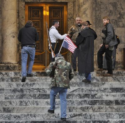 OLYMPIA – Second Amendment rights protestors openly carrying their firearms gathered outside the legislative chambers in the Capitol during a January 2015 protest. Openly carried guns in the galleries were banned shortly after that demonstration. (Jim Camden / The Spokesman-Review)