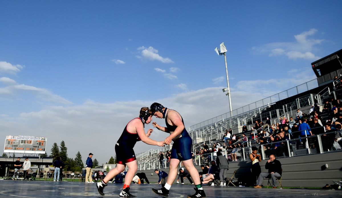 William Delpizzo from Mt Spokane, left, and Grant Carroll from Mead took to the mat during the first ever GSL outside wrestling meet at Union Stadium on Thursday, May 27, 2021.  (Kathy Plonka/The Spokesman-Review)
