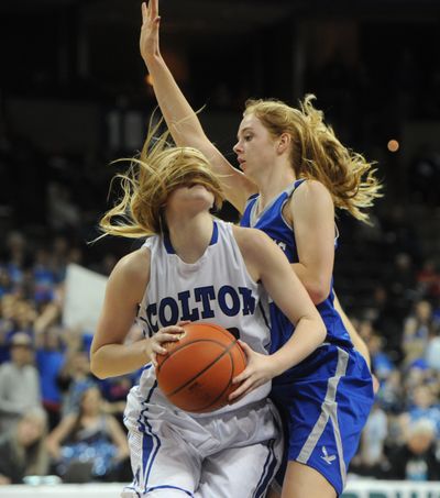 Colton's Jackie Warner gets wrapped up by her hair and the Tekoa-Oakesdale defense in the first half. (Tyler Tjomsland)