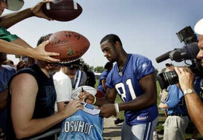 
Detroit Lions wide receiver Calvin Johnson signs autographs after camp on Friday. Associated Press
 (Associated Press / The Spokesman-Review)