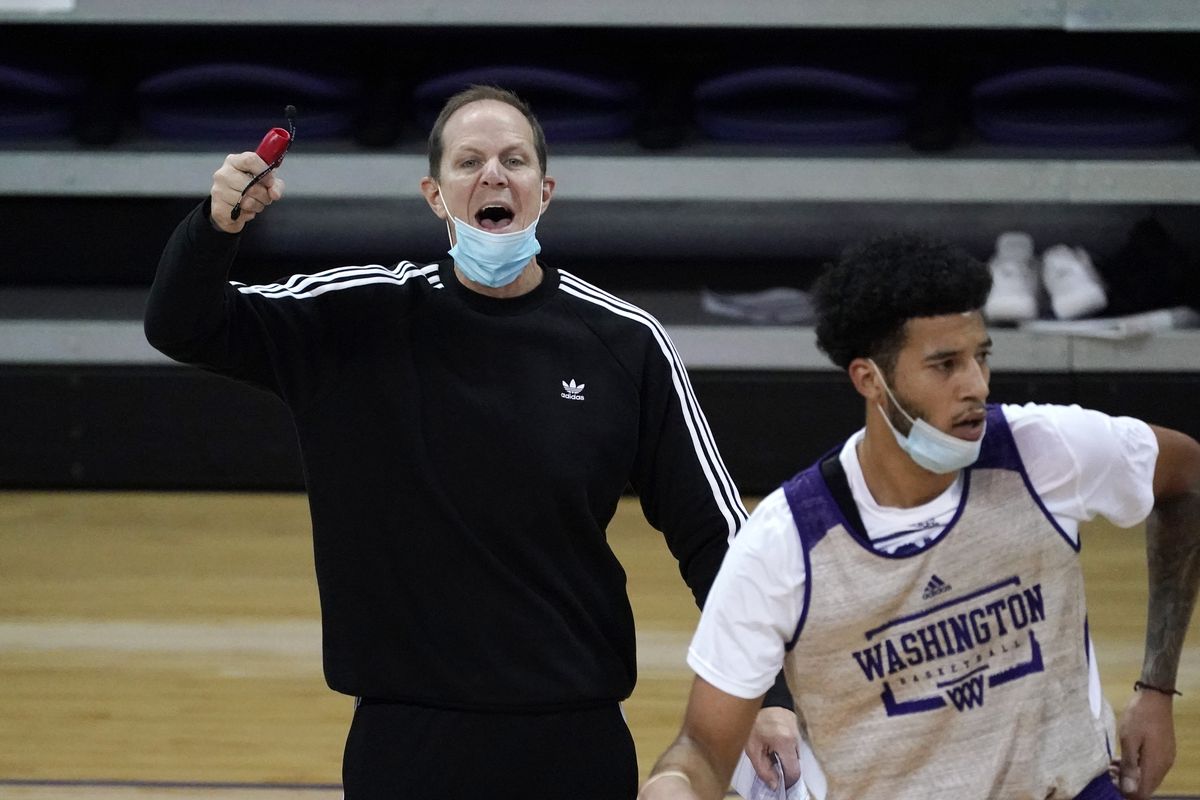 Fourth-year Washington coach Mike Hopkins shouts as forward J’Raan Brooks, a transfer from USC, runs past him during Tuesday’s practice in Seattle. (Associated Press)