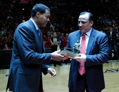 Stu Jackson hands Chicago Bulls coach Tim Thibodeau the coach of the year award on May 2, 2011. Jackson is reportedly set to become the new West Coast Conference commissioner.  (Tribune News Service)