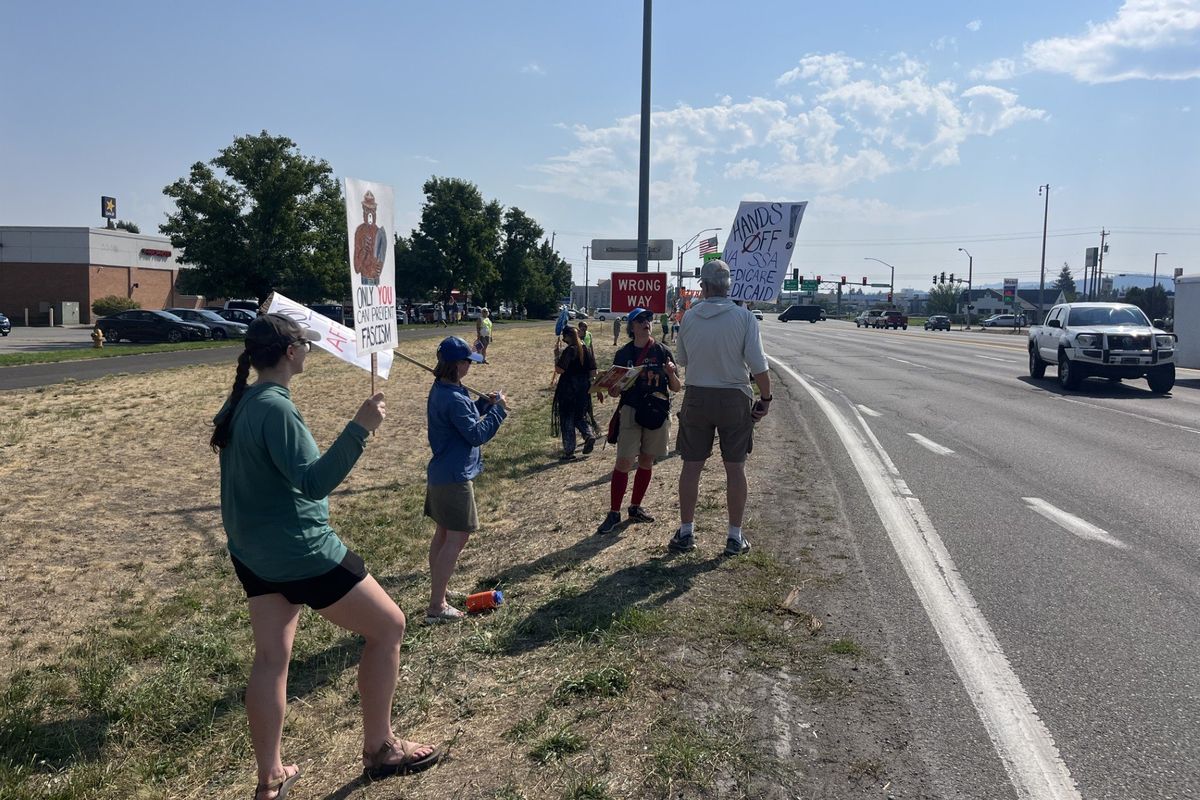 Around 100 people stretched out along U.S. Highway 95 in Coeur d’Alene in one of hundreds of “Workers Over Billionaires” protests around the nation on Labor Day.  (Elena Perry/The Spokesman-Review)