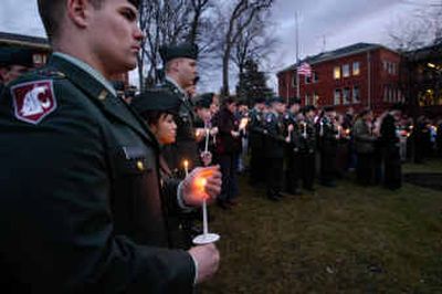 
Cadet Daniel McDougall ends a line of Washington State University ROTC cadets and friends and fellow students of Sgt. Damien Ficek during a candlelight vigil held Wednesday night at the WSU Veterans Memorial. Ficek died in Iraq on Dec. 30 while on patrol in Bahgdad.
 (Photos by Kevin Nibur/ / The Spokesman-Review)