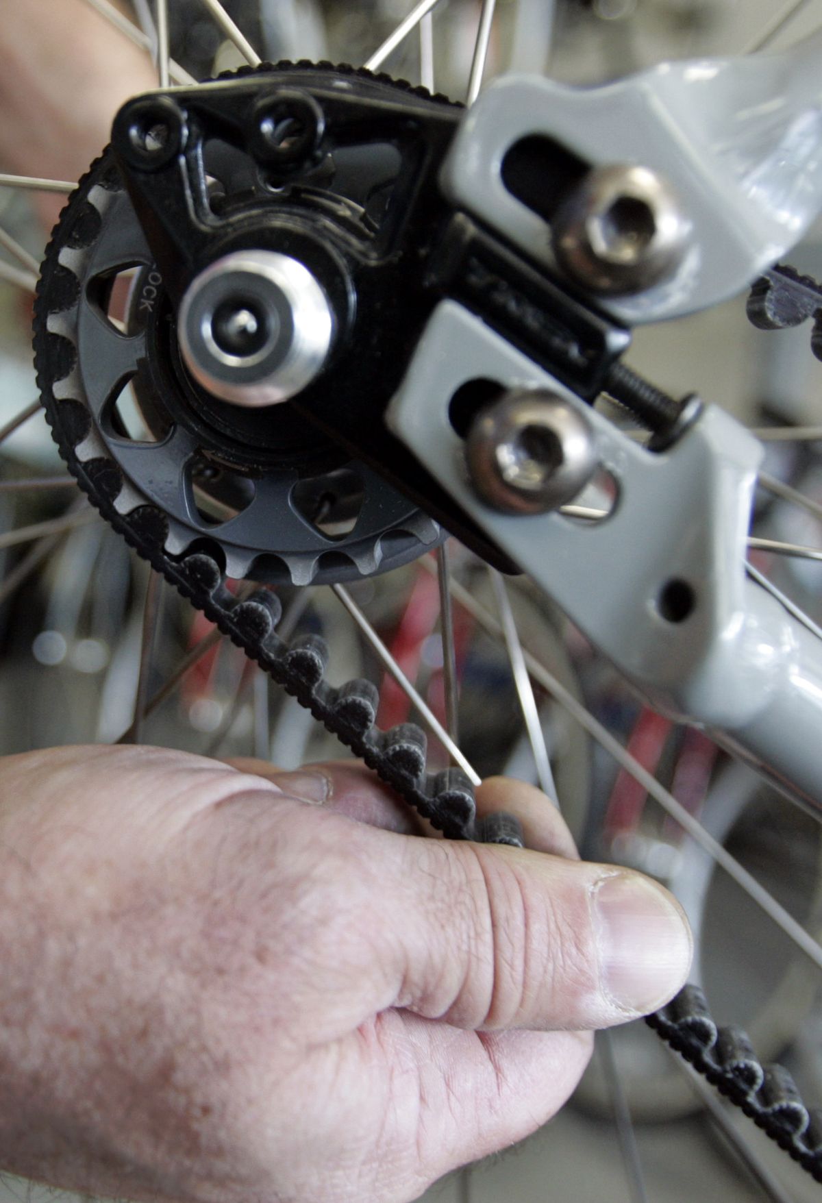 Bicycle shop manager David Oakley, looks over the carbon fiber belt drive of a Trek bike at his shop in Richmond, Va. (Associated Press / The Spokesman-Review)