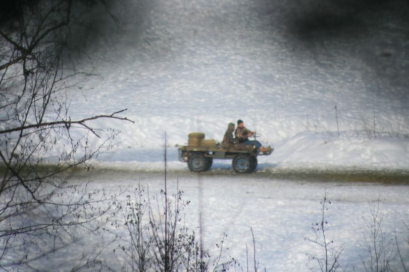 Barbera Johnson and Robert Johnson of Sacramento, Calif., are shown putting out feed to bait elk for the purpose of hunting on the property of Boundary County Idaho landowner Richard Raines. Raines, who is Barbera Johnson's father, also had been documented as putting out bait previously.  This photo was made in mid December 2010 by Idaho Fish and Game officers who later filed illegal hunting charges against the Johnsons. Raines was charged with helping process the illegally killed elk. On Dec. 13, 2010, the three suspects pleaded guilty to various charges and Judge Justin Julien fined them a total of more than $9,000. (Idaho Fish and Game)