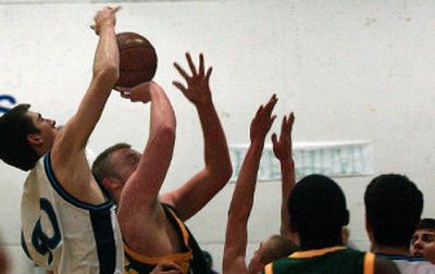 
Gonzaga Prep's Ian Parry, left, gets a hand on the shot of Shadle Park's Josh Landsverk Tuesday during the Bullpups' Greater Spokane League victory. 
 (Brian Plonka / The Spokesman-Review)