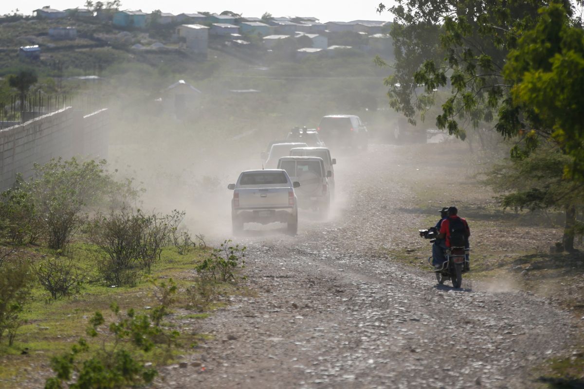 A caravan drives to the airport after departing from the Christian Aid Ministries headquarters at Titanyen, north of Port-au-Prince, Haiti, Dec. 16, 2021. Twelve remaining members of a U.S.-based missionary group who were kidnapped two months ago have been freed, according to the group and to Haitian police.  (Odelyn Joseph)