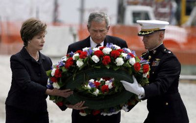 
President Bush, first lady Laura Bush and  Marine Corps Maj. Mark Thompson prepare to lay a memorial wreath in a reflecting pool at ground zero on Sunday. 
 (Associated Press / The Spokesman-Review)