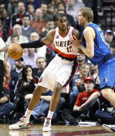 Dallas Mavericks' Dirk Nowitzki, right, defends against Portland Trail Blazers' LaMarcus Aldridge (12). (Associated Press)