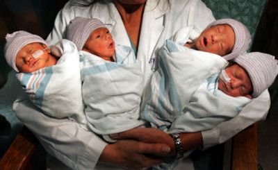 
Dr. Kathryn Shaw holds the two boys and two girls born to Angela Magdaleno, at the White Memorial Medical Center in Los Angeles on Wednesday. The quadruplets were born July 6 at the center. 
 (Associated Press / The Spokesman-Review)