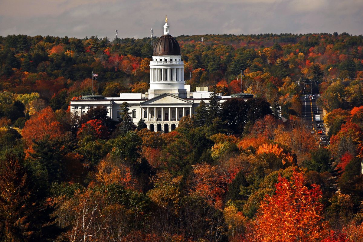 In this Oct. 23, 2017 photo, the State House is surrounded by fall foliage in Augusta, Maine. Recent leaf-peeping seasons have been disrupted by weather conditions in New England, New York and elsewhere. Arborists and ecologists say the trend is likely to continue as the planet warms.  (Robert F. Bukaty)