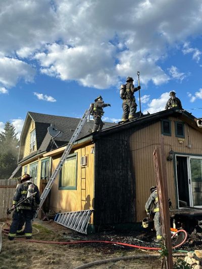 Spokane firefighters work to extinguish a house fire Friday in the Chief Garry Park Neighborhood.  (Courtesy of Spokane Fire Department)