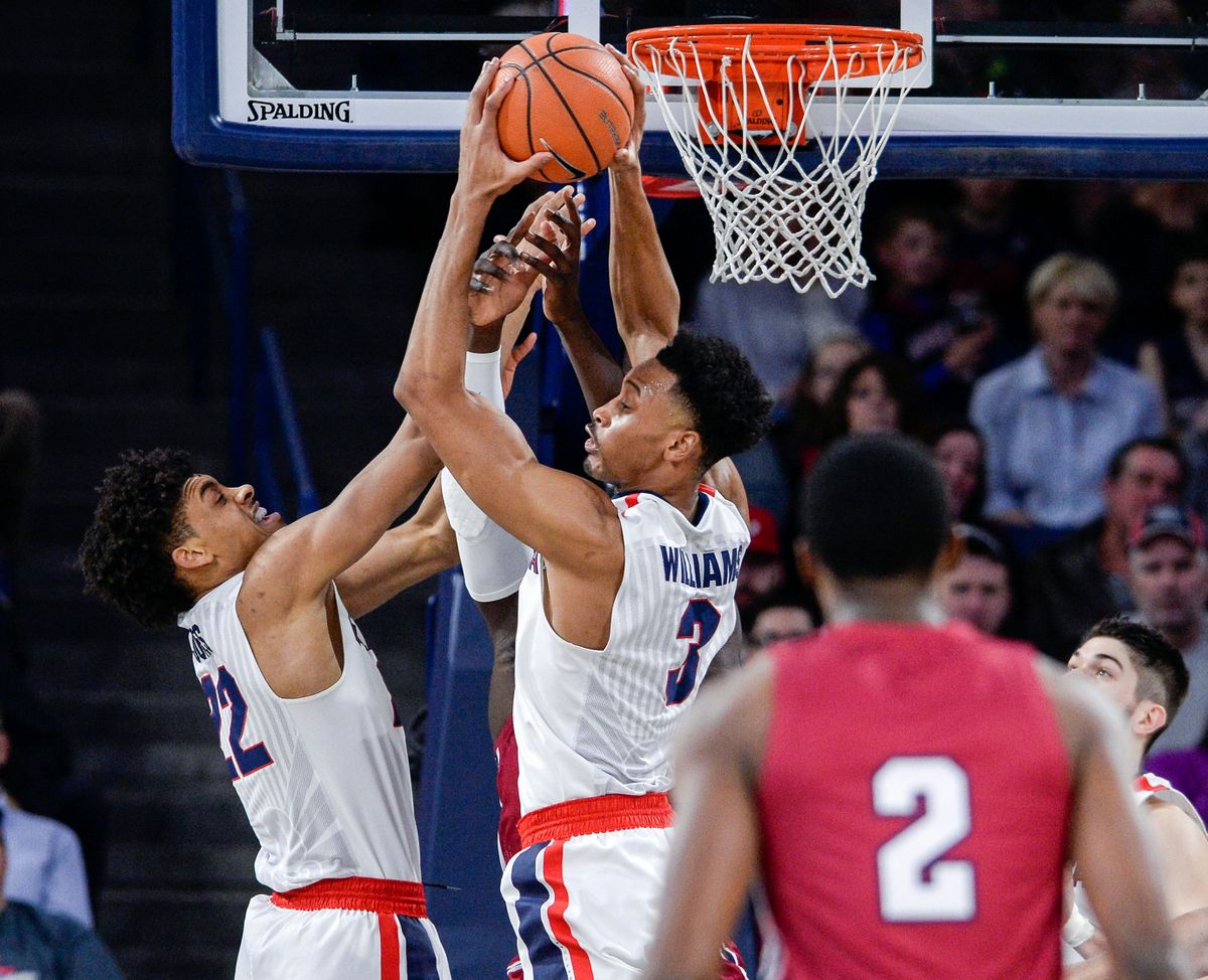 Gonzaga’s Johnathan Williams (3) and Jeremy Jones (22) control the boards against Loyola Marymount in a Feb., 2018 home game.  (Dan Pelle/The Spokesman-Review)