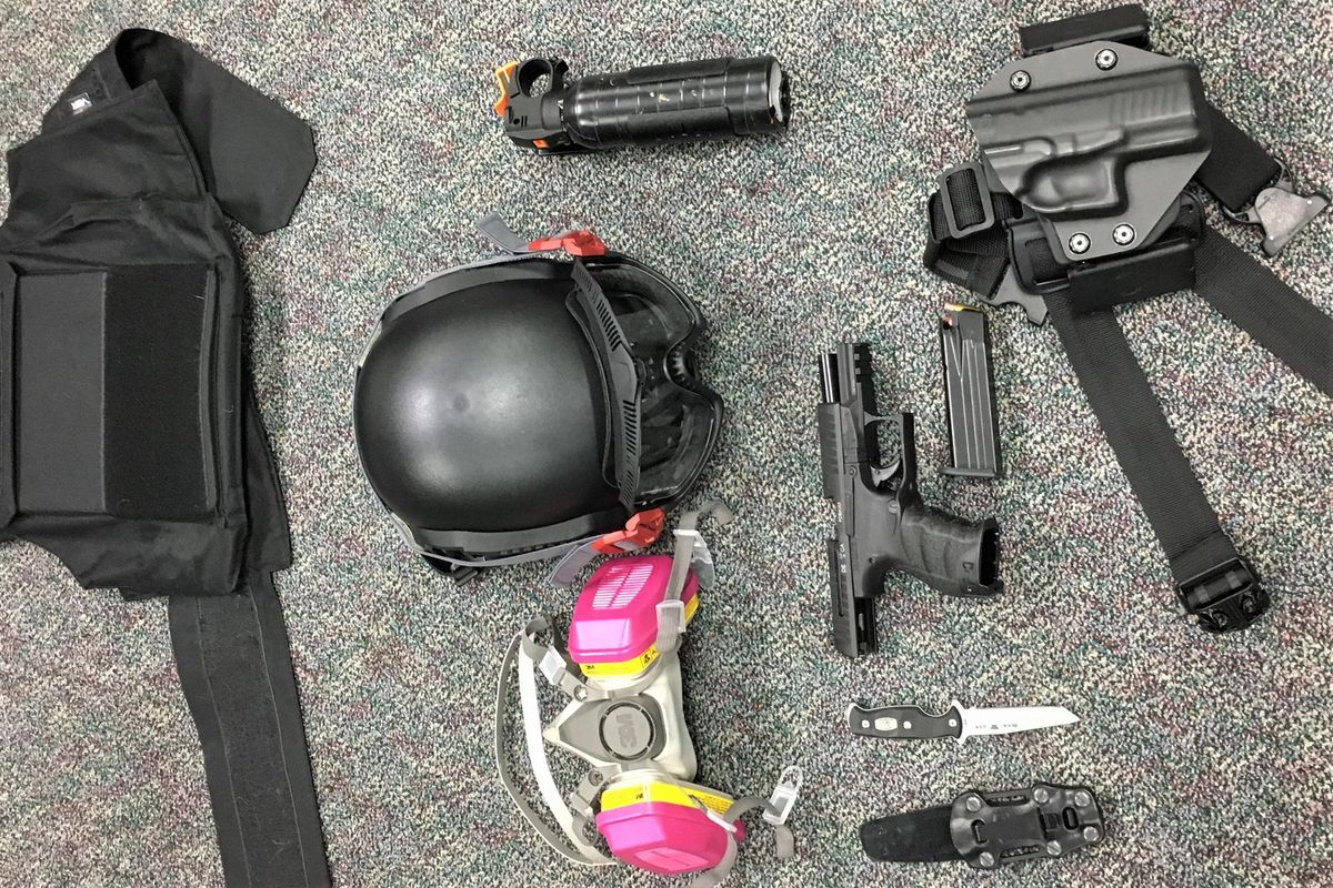 This Friday, March 12, 2021, photo released by Portland Police Bureau shows numerous items left behind by people inside the perimeter of a march, including a crowbar, hammers, bear spray, slugging weapon with rocks, high impact slingshot, and knives, after they corralled a group of about 100 hundred protesters Friday night in Portland, Ore. On Saturday, March 13, 2021, police said officers surrounded protesters about 15 minutes after the march began in the city