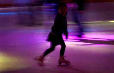 
Six-year-old Lilly Pierce, of Spokane, skates under Planet Ice's colored lights on Saturday. 
 (The Spokesman-Review)