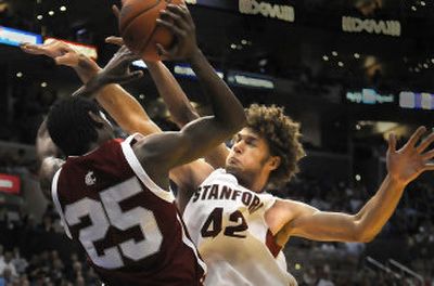 
Robin Lopez of Stanford, right, swats at the ball but winds up knocking Kyle Weaver of WSU out of bounds during the first half Friday. 
 (CHRISTOPHER ANDERSON / The Spokesman-Review)