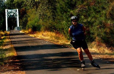 
Nancy Sim, of Toronto, Canada skates The Trail of the Coeur d'Alenes in Enaville on Wednesday. She is part of a group of inline skaters spending five days skating the Trail of the Coeur d'Alenes and Centennial Trail. 
 (The Spokesman-Review)