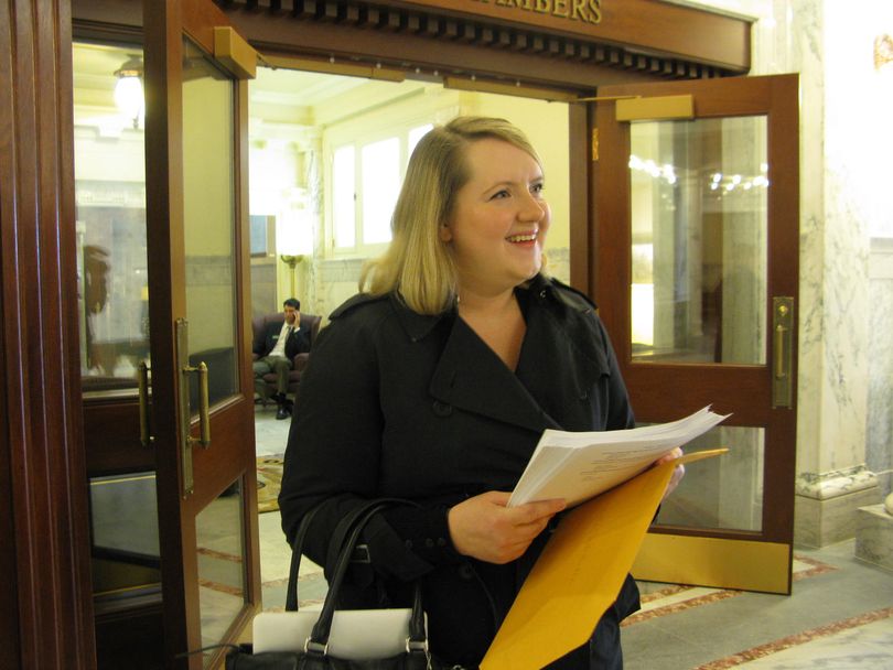 Emily Walton delivers petitions to the House on Wednesday opposing the guns-on-campus bill (Betsy Russell)