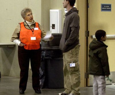 
SCOPE volunteer Bobbie Baker speaks with a patron at the Spokane Regional Health District's free distribution of FluMist at the Spokane Fair and Expo Center Nov. 15. 
 (Liz Kishimoto / The Spokesman-Review)