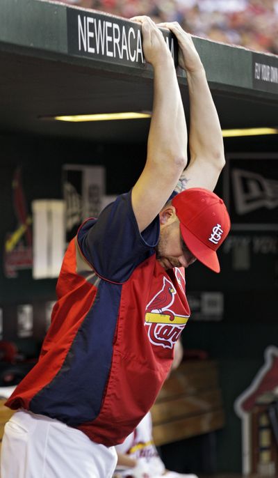 Dugout stretches weren’t enough to get Chris Carpenter healthy. (Associated Press)