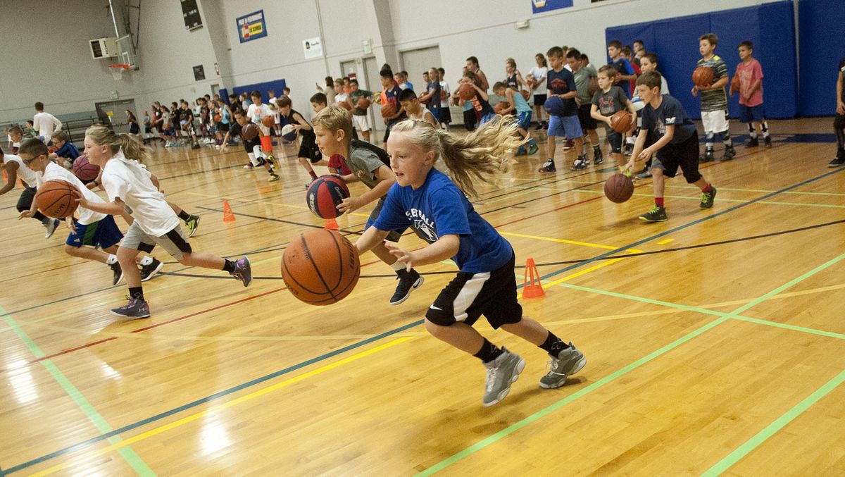 Eight-year-old Keely Handran of Spokane Valley dribbles down the court during basketball camp run by Nigel Williams-Goss at The Hub in Liberty Lake on Tuesday, Aug. 22, 2017. (Kathy Plonka / The Spokesman-Review)
