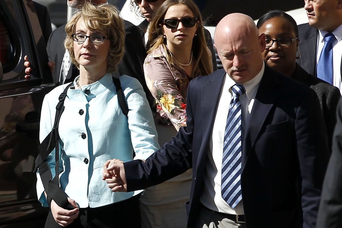 Former Democratic Rep. Gabrielle Giffords and her husband, Mark Kelly, leave after the sentencing of Jared Loughner, in back of U.S. District Court Thursday in Tucson, Ariz. Loughner, 24, was sentenced to life in prison. (Associated Press)
